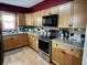 Updated kitchen featuring stainless steel appliances and wood cabinets at 719 Henry St, Lebanon, IN 46052