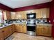 Kitchen featuring stainless steel appliances and wood cabinets at 719 Henry St, Lebanon, IN 46052