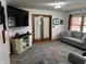 Comfortable living room with neutral tones, including a large TV and sliding barn door entertainment center at 719 Henry St, Lebanon, IN 46052