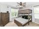 ' bedroom with bunk bed, neutral walls and carpet, and a window with curtains at 7214 Morello Ln, Noblesville, IN 46062