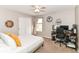 Relaxing bedroom featuring a neutral color palette, a ceiling fan, and a conveniently located desk space at 7214 Morello Ln, Noblesville, IN 46062