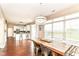 Bright dining area featuring wood floors, a rustic table with seating, and large windows offering natural light at 7214 Morello Ln, Noblesville, IN 46062