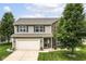 Charming two-story home featuring brick and siding, a well-manicured lawn, and mature trees at 7214 Morello Ln, Noblesville, IN 46062