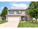 Charming two-story home with a two-car garage, complemented by a well-manicured lawn and beautiful landscaping at 7214 Morello Ln, Noblesville, IN 46062