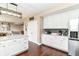 Modern kitchen with white cabinets, stainless steel appliances, and a center island with seating at 7214 Morello Ln, Noblesville, IN 46062