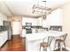 Bright kitchen features white cabinetry, stainless steel appliances, and bar seating at 7214 Morello Ln, Noblesville, IN 46062