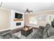 Cozy living area with a shiplap fireplace, comfortable seating, and a contemporary decorative rug at 7214 Morello Ln, Noblesville, IN 46062
