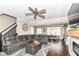 Spacious living area with open layout, a large sectional, and a view into the dining area with lots of natural light at 7214 Morello Ln, Noblesville, IN 46062