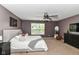 Main bedroom featuring neutral carpet, bed with white comforter, and ceiling fan at 7214 Morello Ln, Noblesville, IN 46062