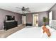 Spacious main bedroom with dark purple walls, neutral carpet, and ceiling fan at 7214 Morello Ln, Noblesville, IN 46062