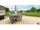 Enjoy outdoor dining on this patio, featuring a grill, table set, and a scenic view of the pond at 7214 Morello Ln, Noblesville, IN 46062