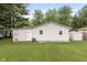 Backyard view showcasing the home's exterior with a well-maintained lawn, shed, and privacy fencing at 724 Alexander St, Greenwood, IN 46143