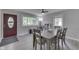 Bright dining room boasts a gray-toned table with six chairs, complemented by light wood floors at 724 Alexander St, Greenwood, IN 46143