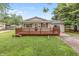 Charming single-story home featuring a large front yard and inviting wood deck at 724 Alexander St, Greenwood, IN 46143