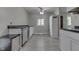 Kitchen featuring white cabinets, stainless dishwasher and light gray flooring at 724 Alexander St, Greenwood, IN 46143