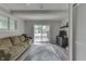 Comfortable living room featuring a cozy sofa, entertainment center, and a sliding glass door at 724 Alexander St, Greenwood, IN 46143