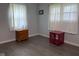 Bright bedroom with neutral walls, two windows with white curtains, and modern furniture, perfect for relaxation and comfort at 75 Byram Blvd, Martinsville, IN 46151