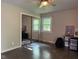 A clean bedroom with natural light, ceiling fan, and a large mirrored closet at 75 Byram Blvd, Martinsville, IN 46151