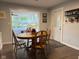 Cozy dining room features dark wood floors and a round wood table with chairs and a decorative accent piece at 75 Byram Blvd, Martinsville, IN 46151