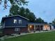 Charming two-story home with a brick base, blue siding, covered porch, and well-manicured front yard at 75 Byram Blvd, Martinsville, IN 46151