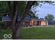 Charming split-level home featuring a brick facade, blue siding, covered porch and large garage at 75 Byram Blvd, Martinsville, IN 46151
