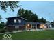 Charming split-level home featuring a brick facade, blue siding, covered porch and large garage at 75 Byram Blvd, Martinsville, IN 46151
