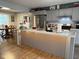 Open kitchen design with a large island, stainless steel refrigerator, and a cozy dining area at 75 Byram Blvd, Martinsville, IN 46151