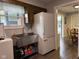Laundry room featuring stainless steel sink, adjacent to the kitchen and dining area at 75 Byram Blvd, Martinsville, IN 46151
