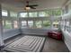 Bright sunroom with lots of large windows, hardwood floors, a ceiling fan, and a decorative rug at 75 Byram Blvd, Martinsville, IN 46151