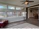 Spacious sunroom offers plenty of natural light with walls of windows and hardwood floors at 75 Byram Blvd, Martinsville, IN 46151