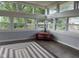 Bright sunroom with lots of large windows, hardwood floors, and a decorative rug at 75 Byram Blvd, Martinsville, IN 46151