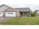 Charming brick home with a two-car garage and a cozy front porch seating area at 7632 Sea Crest N Way, Noblesville, IN 46062
