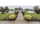 Picturesque gazebo overlooking a pond, framed by lush greenery and colorful landscaping at 7632 Sea Crest N Way, Noblesville, IN 46062
