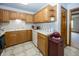 A well-lit kitchen with wooden cabinetry, white appliances, and tile flooring at 7632 Sea Crest N Way, Noblesville, IN 46062