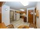 Traditional kitchen with wood cabinets, white appliances, and neutral tile flooring at 7632 Sea Crest N Way, Noblesville, IN 46062