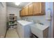 Bright laundry room with a utility sink, built-in cabinets, and washer and dryer at 7632 Sea Crest N Way, Noblesville, IN 46062