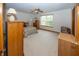Cozy main bedroom with wooden furniture, plush carpet, and a bright window at 7632 Sea Crest N Way, Noblesville, IN 46062