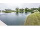 Beautiful pond view with lush greenery and a charming barn structure in the background at 7632 Sea Crest N Way, Noblesville, IN 46062