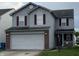 Traditional two-story home featuring a two-car garage, red shutters and vinyl siding at 8056 Maple Stream Blvd, Indianapolis, IN 46217