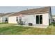 Backyard patio area with outdoor seating, a fire pit, and a well-manicured lawn at 8148 Gathering Cir, Indianapolis, IN 46259