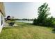 Backyard overlooking a serene pond, featuring a patio, green lawn, and mature trees at 8148 Gathering Cir, Indianapolis, IN 46259