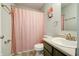 Bathroom featuring gray walls, framed mirror, wood-look floors, and a shower with pink shower curtain at 8148 Gathering Cir, Indianapolis, IN 46259
