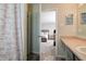 Bathroom view leading to the bedroom, showcasing a decorated shower curtain and vanity at 8148 Gathering Cir, Indianapolis, IN 46259