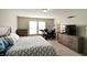 This bedroom is furnished with a queen bed, dresser, and dedicated workspace near natural light at 8148 Gathering Cir, Indianapolis, IN 46259