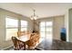 Dining area with natural light, a view of the pond, and wood flooring at 8148 Gathering Cir, Indianapolis, IN 46259