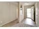 Inviting entryway featuring a neutral color palette, wood-look flooring, and a carpeted living space at 8148 Gathering Cir, Indianapolis, IN 46259