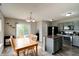 Eat-in kitchen with a wooden table, slider, and view to the backyard at 8148 Gathering Cir, Indianapolis, IN 46259