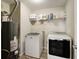 Laundry area with front-load washer and dryer and wire shelving at 8148 Gathering Cir, Indianapolis, IN 46259