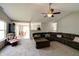 Open-concept living room features plush seating, a ceiling fan, and a view of the dining area at 8148 Gathering Cir, Indianapolis, IN 46259