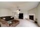 Bright living room features neutral carpet, brick fireplace, and comfortable seating arrangement at 8148 Gathering Cir, Indianapolis, IN 46259